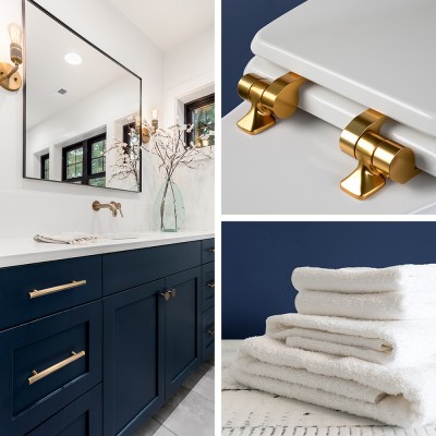 Bathroom settings showing navy cabinets and mirror, white toilet seat with gold hinges, and stack of white towels