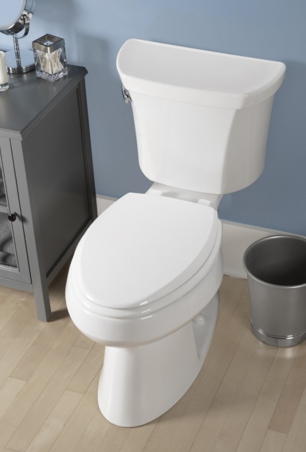 Top down view of white toilet against a blue wall