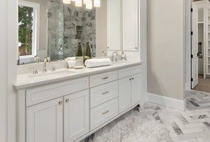 Modern bathroom with white vanity, double sink and large mirror