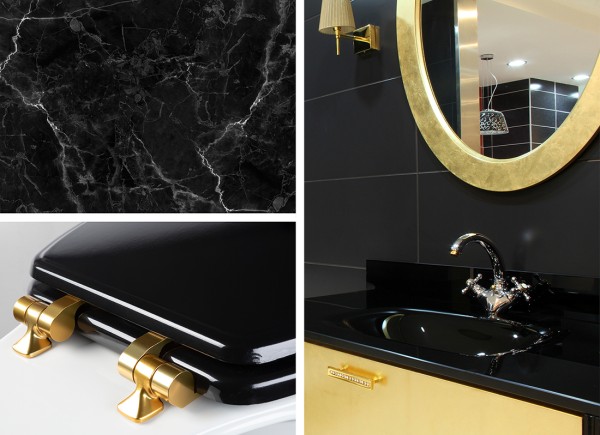 Black bathroom decoration including black toilet seat with gold hinges, black marble tile and black sink with gold mirror