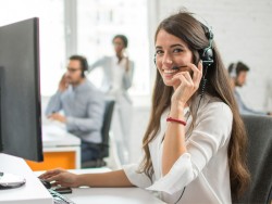Smiling customer service woman using headset