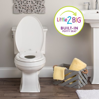 Little to Big toilet seat on the toilet with box of towels on floor